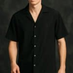 Crispy black short-sleeve button-up shirt for men, modern casual style, stylish men's fashion piece, versatile black shirt for everyday wear.
