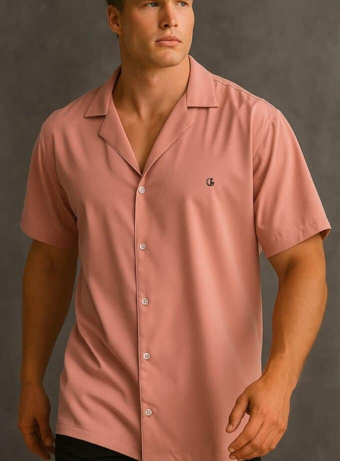 Bright pink short-sleeve button-up shirt with a small logo, stylish and casual, perfect for summer or relaxed occasions.