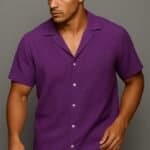 Purple casual men's short-sleeve shirt with notched collar, front buttons, and small embroidered logo, perfect for stylish summer or warm weather fashion.