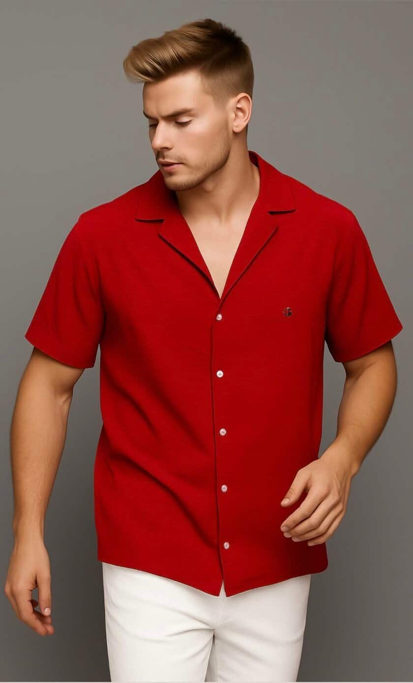 Red short-sleeve button-up shirt for men, casual summer fashion, styled with white pants, modern men's apparel, lightweight and comfortable clothing, suitable for warm weather and stylish occasions.