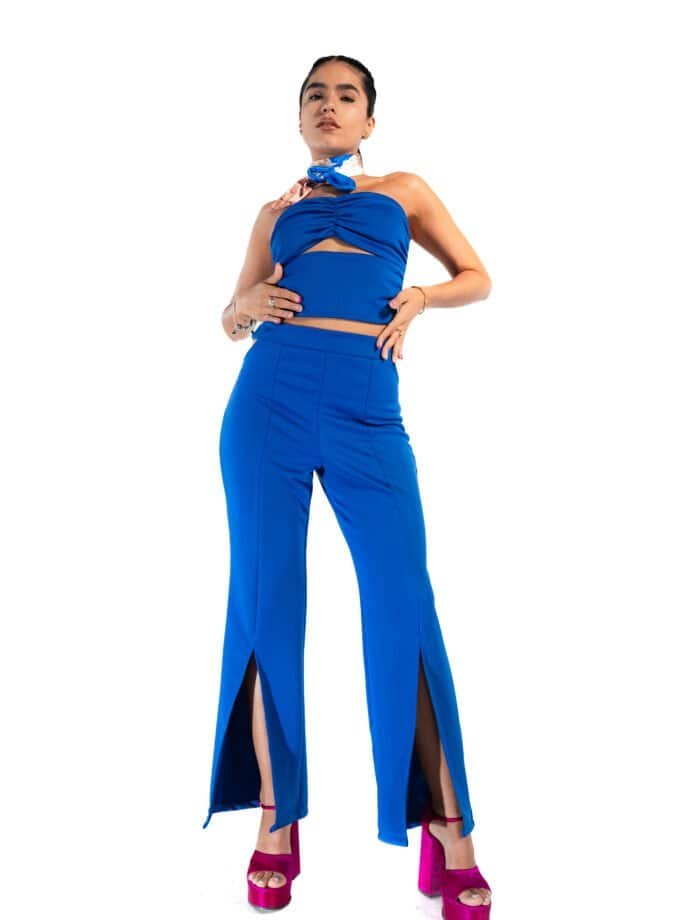 Blue stylish fashion outfit with slits and high heels for women in a studio setting.