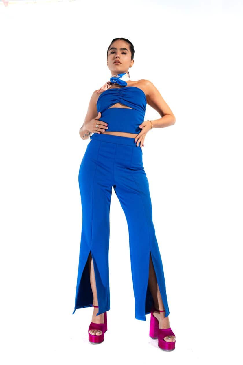 Blue stylish fashion outfit with slits and high heels for women in a studio setting.