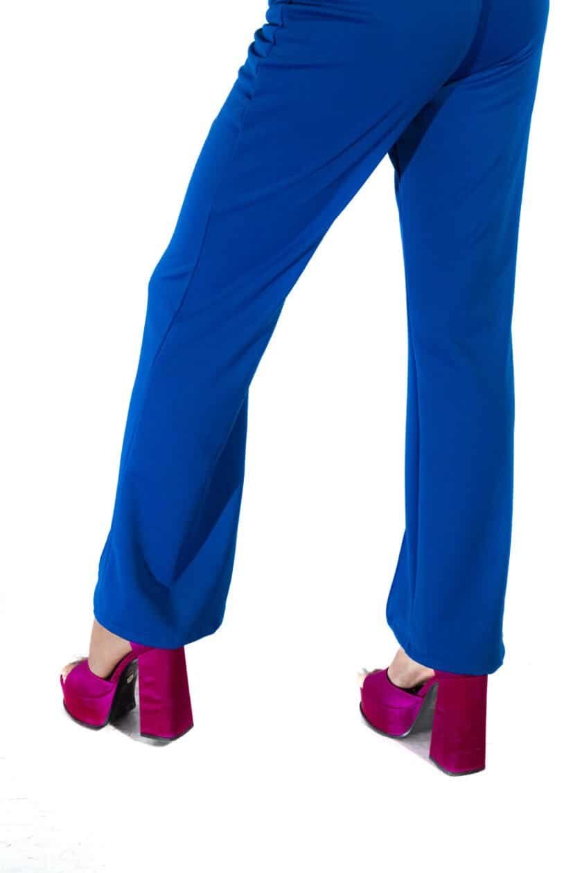 Pink velvet high heel shoes paired with bright blue wide-leg trousers, showcasing fashionable and vibrant footwear options for women. Perfect for style-conscious individuals seeking bold accessories.