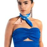 Sassy woman in blue strapless top with colorful silk neck scarf, fashion, modern style, confident woman, accessorized with earrings and bracelet.