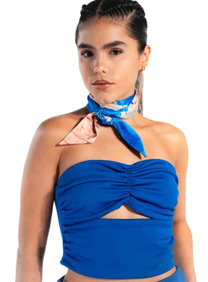 Sassy woman in blue strapless top with colorful silk neck scarf, fashion, modern style, confident woman, accessorized with earrings and bracelet.