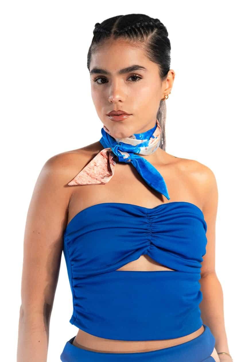 Sassy woman in blue strapless top with colorful silk neck scarf, fashion, modern style, confident woman, accessorized with earrings and bracelet.