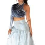 Vegan woman wearing a stylish, abstract black and white crop top paired with a flowing white maxi skirt, emphasizing modern fashion, fitness, and sustainable clothing.