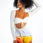 Colorful woman's fashion photoshoot showcasing stylish colorful pants and white top, emphasizing bold fashion choices for modern summer looks.