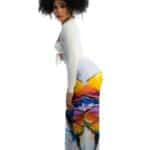 Silk blouse and wide-leg printed pants with a colorful abstract landscape design, fashion-forward womenswear, stylish outfit, modern streetwear, summer clothing, vibrant print, chic fashion look.