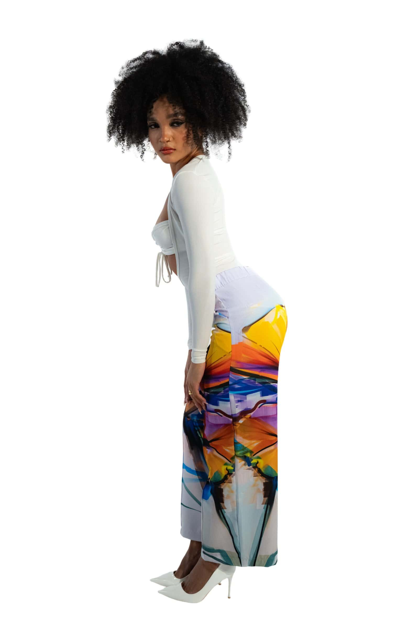 Silk blouse and wide-leg printed pants with a colorful abstract landscape design, fashion-forward womenswear, stylish outfit, modern streetwear, summer clothing, vibrant print, chic fashion look.