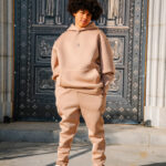 Comfortable beige hoodie and sweatpants set with minimalist logo, stylish streetwear fashion, perfect casual look, modern urban clothing, comfortable outfit for everyday wear.