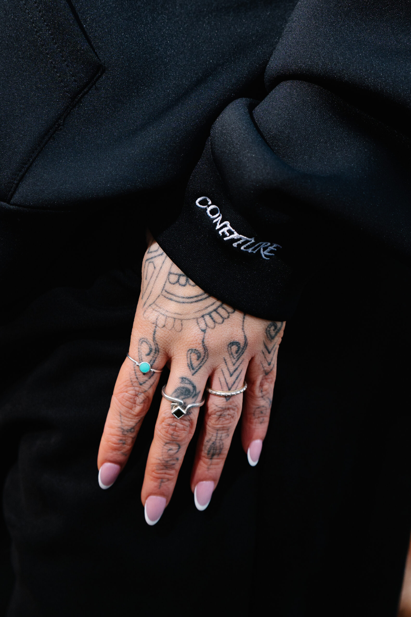 Vintage black jacket with "CONFEUTURE" embroidered on the sleeve, showcasing trendy streetwear style.